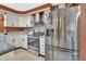 Well lit kitchen with stainless steel appliances, granite countertops, and rustic wood backsplash at 535 Black Ironwood Dr, Deland, FL 32724