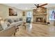 Cozy living room with a stone fireplace, plush seating, and a serene atmosphere at 535 Black Ironwood Dr, Deland, FL 32724