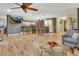 Open layout showing the living room flowing into the kitchen, with a bar and hardwood floors at 535 Black Ironwood Dr, Deland, FL 32724