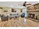 Comfortable living room featuring a stone fireplace, soft lighting, and a peaceful ambiance at 535 Black Ironwood Dr, Deland, FL 32724