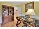 Home office featuring wood floors, shelving and a desk area at 535 Black Ironwood Dr, Deland, FL 32724