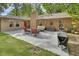 Spacious backyard patio with outdoor seating, barbecue grill, and a brick chimney at 535 Black Ironwood Dr, Deland, FL 32724