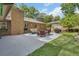 Spacious backyard patio features a barbecue grill and outdoor seating adjacent to home at 535 Black Ironwood Dr, Deland, FL 32724