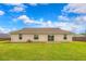 Backyard view of the house, lawn and sliding glass door at 6 Laurel Pass Ct, Ocala, FL 34480