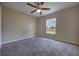 A bright bedroom features a ceiling fan and a window with blinds at 6 Laurel Pass Ct, Ocala, FL 34480