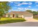 Charming single-story home boasts a well-manicured lawn, attached two-car garage, and neutral color palette at 6 Laurel Pass Ct, Ocala, FL 34480