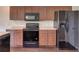 Kitchen features wood cabinets, black appliances, and laminate countertops at 6 Laurel Pass Ct, Ocala, FL 34480
