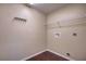 Functional laundry room with a wire shelf, hook rack, and laundry connections at 6 Laurel Pass Ct, Ocala, FL 34480