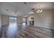 Open concept living room showcases wood flooring, vaulted ceilings, and access to the kitchen and backyard at 6 Laurel Pass Ct, Ocala, FL 34480