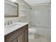 Bathroom featuring dark cabinets, light countertops, a mirror, toilet, and tub with shower at 600 N Boundary Ave # 110A, Deland, FL 32720