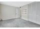 Large bedroom featuring light gray carpet, double closets, and shelving at 600 N Boundary Ave # 110A, Deland, FL 32720