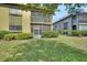 Condominium exterior featuring a well-maintained lawn and mature landscaping at 600 N Boundary Ave # 110A, Deland, FL 32720