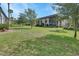 Two-story condominium surrounded by a lush green lawn and mature shade trees at 600 N Boundary Ave # 110A, Deland, FL 32720