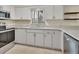 Bright kitchen featuring stainless steel appliances, granite countertops, and white cabinetry at 600 N Boundary Ave # 110A, Deland, FL 32720