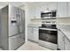 Updated kitchen featuring stainless steel appliances, granite counters, and clean white cabinetry at 600 N Boundary Ave # 110A, Deland, FL 32720