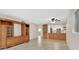 Spacious living room features built-in cabinets, ceiling fan, tile flooring and connects to the kitchen at 600 N Boundary Ave # 110A, Deland, FL 32720