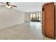 Living room showcasing the tile floors, ceiling fan, and sliding glass door to the screened-in porch at 600 N Boundary Ave # 110A, Deland, FL 32720