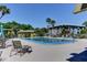 Community pool area with lounge chairs and lush landscaping at 600 N Boundary Ave # 110A, Deland, FL 32720