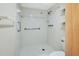 Walk-in shower featuring white tile and grab bars, perfect for accessibility at 600 N Boundary Ave # 110A, Deland, FL 32720