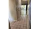 Tiled hallway leading to a bright living area with sliding glass doors, creating an inviting transition at 621 W Indiana Ave # 13, Deland, FL 32720