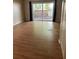 Open living area with laminate flooring and sliding glass doors, creating a light and airy space at 621 W Indiana Ave # 13, Deland, FL 32720