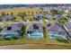 Aerial view of homes with screened in pools in a lakeside community at 6871 Forkmead Ln, Port Orange, FL 32128