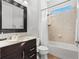Bright bathroom featuring a shower-tub combo and a dark wood vanity with a neutral countertop at 6871 Forkmead Ln, Port Orange, FL 32128