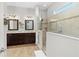 The bright bathroom boasts double sinks, stylish lighting and an enclosed glass shower at 6871 Forkmead Ln, Port Orange, FL 32128