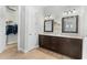 This bathroom features dual sinks, stunning vanity, and a closet for storage at 6871 Forkmead Ln, Port Orange, FL 32128