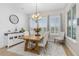 Bright dining room with shiplap accent wall, chandelier, and large windows overlooking the backyard at 6871 Forkmead Ln, Port Orange, FL 32128