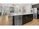 Bright kitchen island featuring stainless steel appliances, dark cabinets and ample counter space at 6871 Forkmead Ln, Port Orange, FL 32128