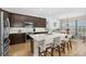 Modern kitchen with stainless steel appliances, a large island, and a dining area at 6871 Forkmead Ln, Port Orange, FL 32128