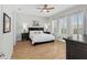 This is the main bedroom showcasing a king bed, ceiling fan, and large windows to provide ample lighting at 6871 Forkmead Ln, Port Orange, FL 32128