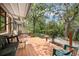 Charming back porch features a swing, outdoor seating, and peaceful views of lush landscaping and the waterway at 71 Crooked Pine Rd, Port Orange, FL 32128
