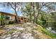 Large backyard with lawn, a deck, and tranquil waterfront views offers a peaceful outdoor living space at 71 Crooked Pine Rd, Port Orange, FL 32128