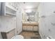 Well-lit bathroom with a toilet, vanity, mirror, and storage shelves in a vintage style at 71 Crooked Pine Rd, Port Orange, FL 32128