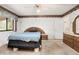 Comfortable bedroom featuring natural light from the window and coordinated furniture and ensuite bathroom at 71 Crooked Pine Rd, Port Orange, FL 32128