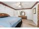 Comfortable bedroom features a double window, wallpaper, closet and furniture with drawers and mirror at 71 Crooked Pine Rd, Port Orange, FL 32128