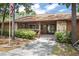 Clubhouse exterior featuring stone accents, a covered porch, and well-maintained landscaping at 71 Crooked Pine Rd, Port Orange, FL 32128
