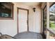 View of the front door from inside the screened porch area at 71 Crooked Pine Rd, Port Orange, FL 32128