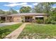Inviting single-story home featuring a well-manicured lawn and charming curb appeal at 71 Crooked Pine Rd, Port Orange, FL 32128