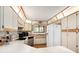Spacious kitchen boasting white cabinets, stainless steel appliances, and laminate flooring at 71 Crooked Pine Rd, Port Orange, FL 32128