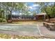 Exterior view shows a community shuffleboard and pool area with benches for players at 71 Crooked Pine Rd, Port Orange, FL 32128