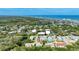 Overhead view of a colorful townhouse community with lush greenery and coastal views at 721 Laurel Bay Cir, New Smyrna Beach, FL 32169