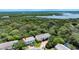Overhead view of townhouses surrounded by trees, greenery, and access to waterfront at 721 Laurel Bay Cir, New Smyrna Beach, FL 32169