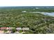 An aerial view showcasing a beautiful townhouse with trees providing shade and privacy at 721 Laurel Bay Cir, New Smyrna Beach, FL 32169