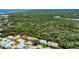 An aerial view of a charming townhouse complex surrounded by lush greenery and waterways at 721 Laurel Bay Cir, New Smyrna Beach, FL 32169