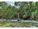 Backyard with string lights, lovely yard, and unique plants offers a perfect spot for relaxation and outdoor enjoyment at 721 Laurel Bay Cir, New Smyrna Beach, FL 32169