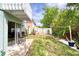 Spacious backyard with string lights, outdoor seating, and tropical plants offering a tranquil spot for relaxation and entertainment at 721 Laurel Bay Cir, New Smyrna Beach, FL 32169