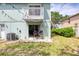 Backyard featuring lush grass and patio, with overhead string lights to create ambiance at 721 Laurel Bay Cir, New Smyrna Beach, FL 32169
